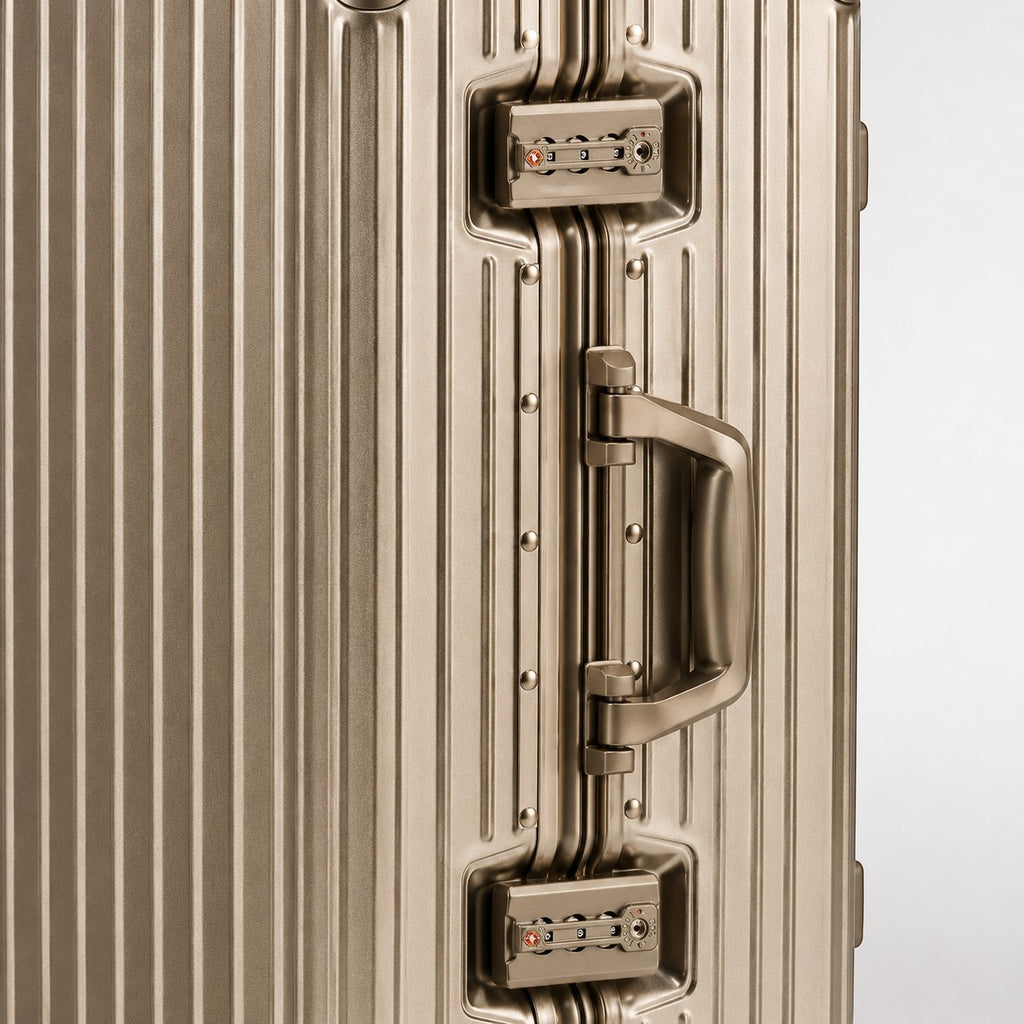 CASE.01 aluminum suitcase in champagne gold with TSA-approved locks and a retractable handle.