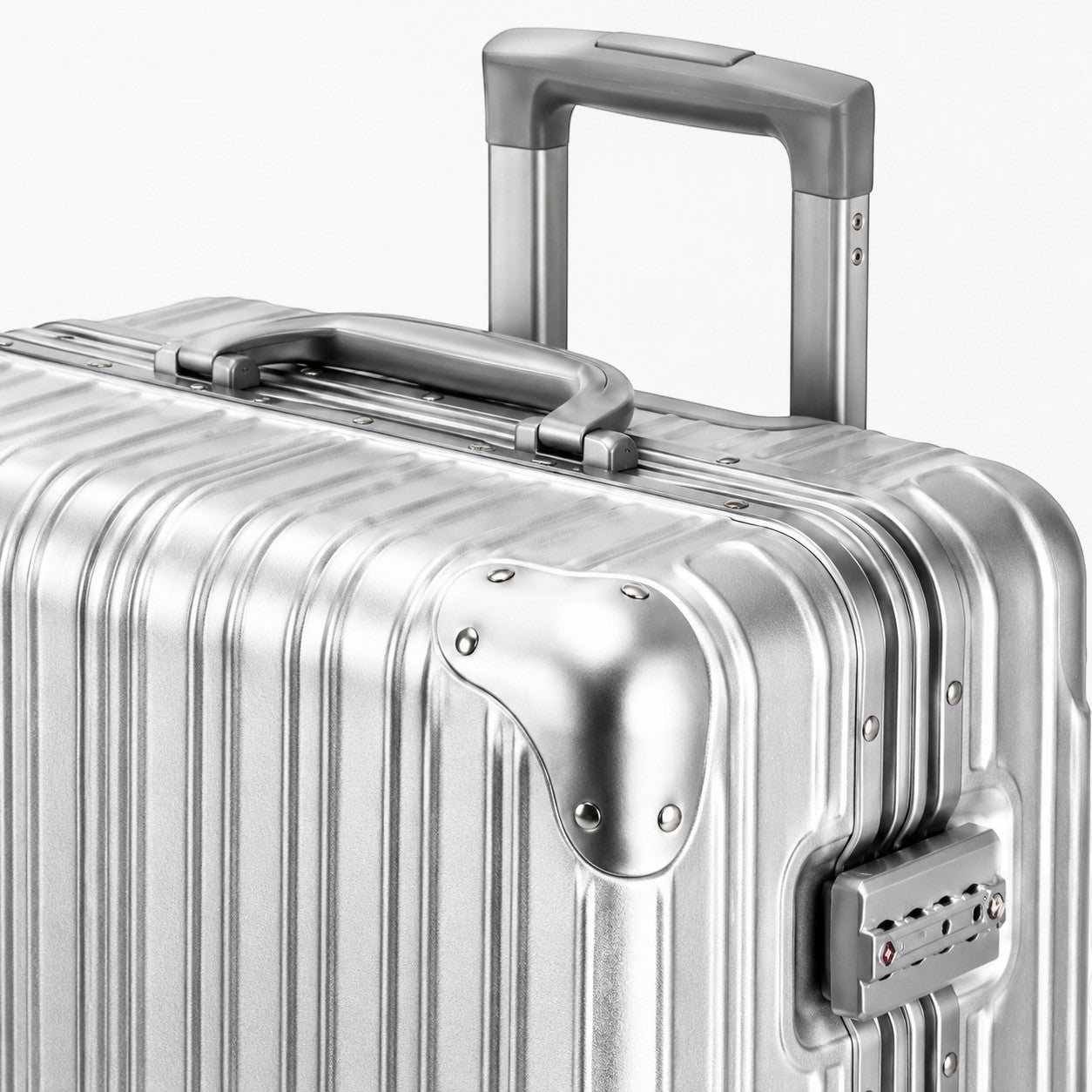 CASE.01 aluminum suitcase with retractable handle and TSA lock. Silver ribbed exterior.
