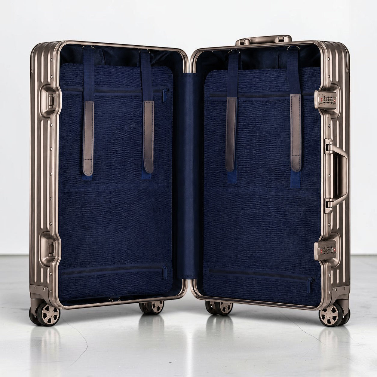 CASE.01 aluminum suitcase with navy blue interior, straps, and zippered pockets. Features TSA locks and spinner wheels.