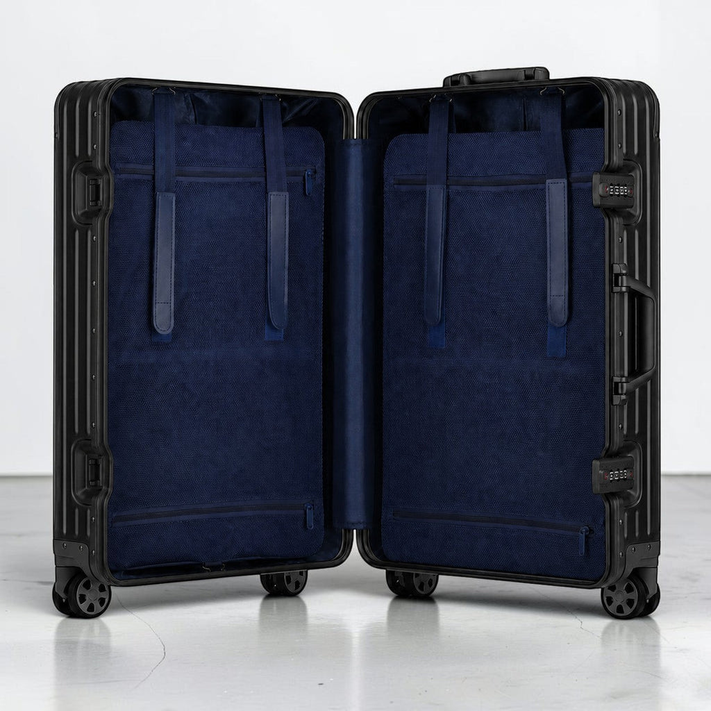 CASE.01 aluminum suitcase with navy blue interior lining and straps, TSA locks, and spinner wheels.