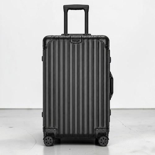 CASE.01 aluminum suitcase in black with ribbed texture, telescopic handle, and spinner wheels.