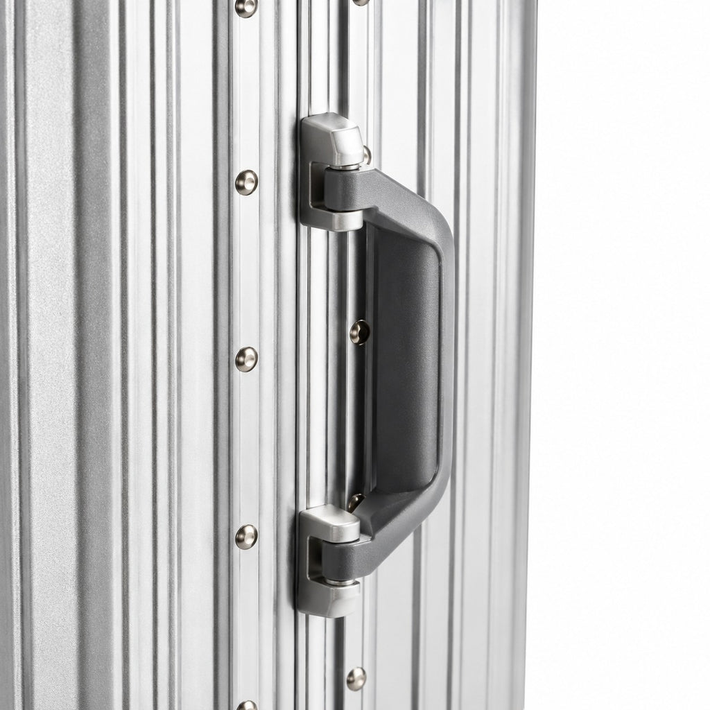 CASE.01 aluminum suitcase with a grey handle and silver rivets. Minimalist design for modern travel.