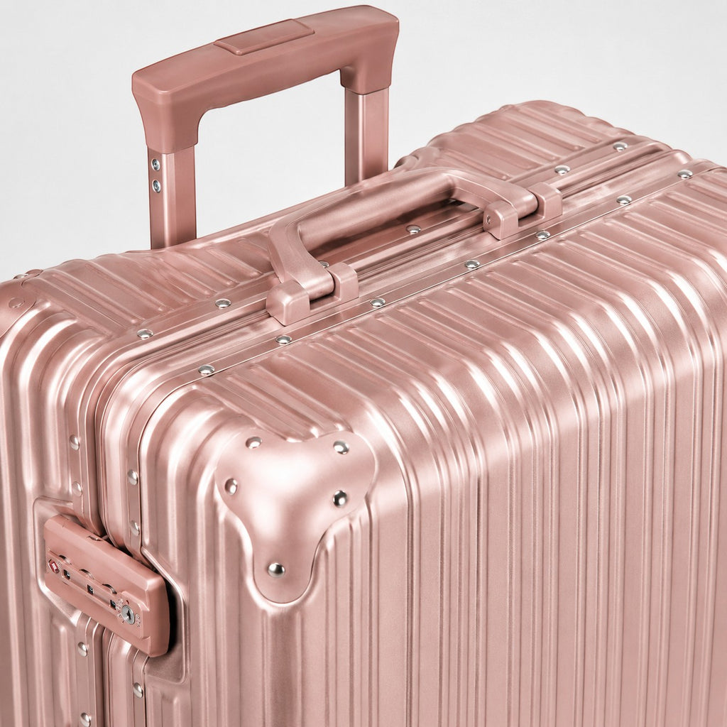 CASE.01 rose gold aluminum suitcase with TSA lock and retractable handle. Minimalist design for modern travelers.