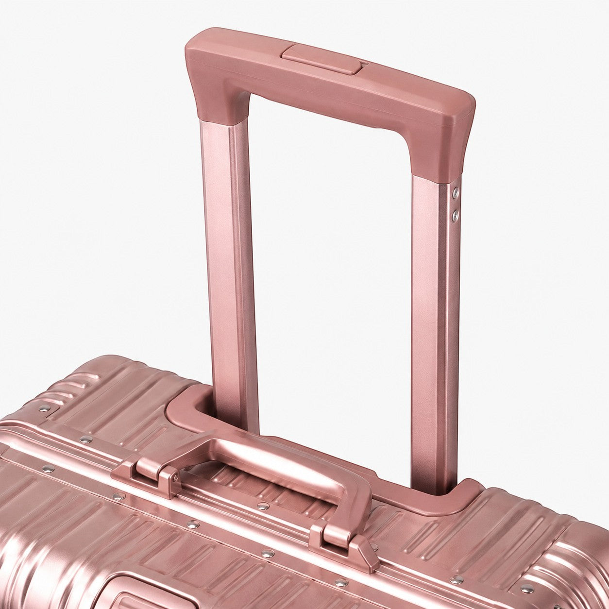 CASE.01 aluminum suitcase in rose gold with a retractable handle and side handle.
